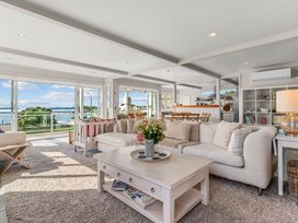 A living room with a sofa and coffee table at Oli Kai - Algies Bay Holiday Home, Algies Bay