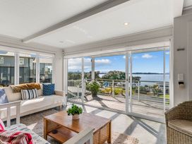 A living room with a sofa and coffee table at Oli Kai - Algies Bay Holiday Home in Algies Bay