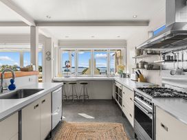 A kitchen with a sink, stove, and cabinets at Oli Kai - Algies Bay Holiday Home, Algies Bay