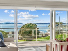 A view of the sea and mountains from a balcony at Oli Kai - Algies Bay Holiday Home in Algies Bay