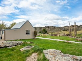 A house with a grassy area and pathway at a property location