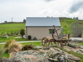 A house with a plow in front and hills in the background at 