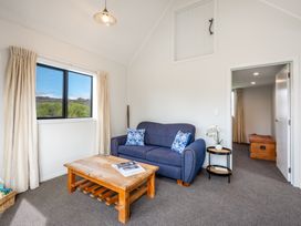 A living room with a sofa, table, and window at the property in location