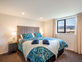 A bedroom with a bed, nightstand and window at 