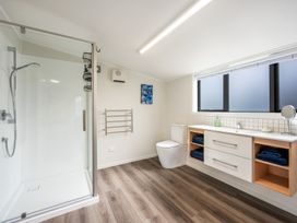 A bathroom with a shower, toilet, and sink at 