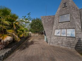 An outdoor area with a house and palm trees at a property in an unspecified location