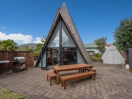 A house with a table and chairs on a patio at The Old Barn in Manchester