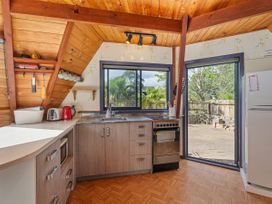 A kitchen with a stove and sink at the property