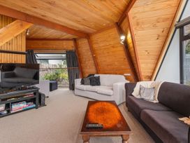 A living room with a television and two sofas at The Old Barn in Manchester