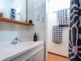 A bathroom with a sink and towels on a rack at the property
