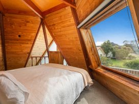 A bedroom with wooden walls and a window at 