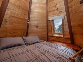 A bedroom with a bed and window at a property