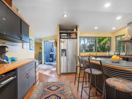 A kitchen with a refrigerator and sink at the property in Whitianga