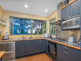 A kitchen with a sink, gas stove, and oven at the property in Whitianga