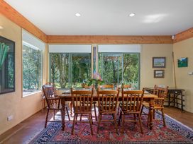 A dining room with a table set for meals at 