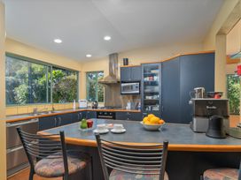 A kitchen with a stove, microwave, and fruit bowl at 