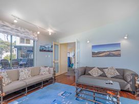 A living room with sofas and a coffee table at The Old Barn in Whitianga