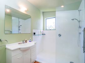 A bathroom with a sink and shower at The Old Barn in Whitianga