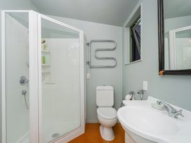A bathroom with a shower, toilet, and sink at 
