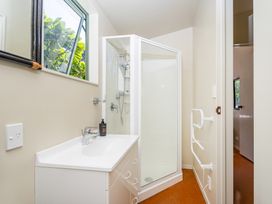 A bathroom with a sink and shower at The Old Barn in Whitianga