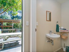 A bathroom with a sink and mirror at the property in Whitianga