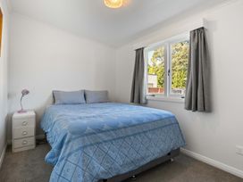 A bedroom with a bed and lamp at The Old Barn in Manchester