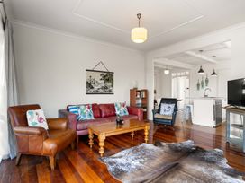 A living room with a sofa and armchair at The Old Barn in Manchester