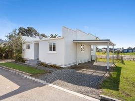 A house with a carport and garden at the property location