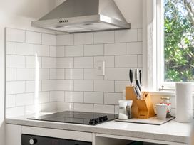 A kitchen with cooking surface and kitchen utensils at 