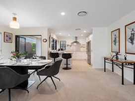 A kitchen and dining area with a table and chairs at Nukuhau Bliss - Taupo Holiday Home Taupo Central