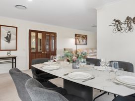 A dining room with a table set for dinner at Nukuhau Bliss - Taupo Holiday Home in Taupo Central