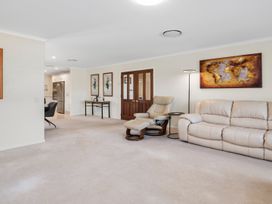 A living room with a sofa and recliner chair at Nukuhau Bliss - Taupo Holiday Home Taupo Central