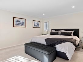 A bedroom with a bed and wall art at Nukuhau Bliss - Taupo Holiday Home Taupo Central