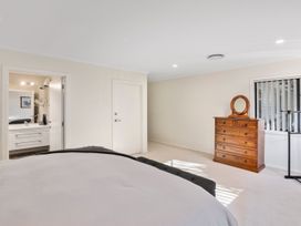 A bedroom with a bed and dresser at Nukuhau Bliss - Taupo Holiday Home Taupo Central