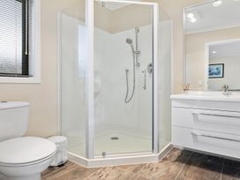 A bathroom with a shower and toilet at Nukuhau Bliss - Taupo Holiday Home Taupo Central
