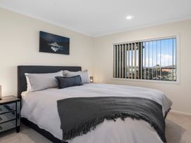 A bedroom featuring a bed with pillows and a nightstand at Nukuhau Bliss - Taupo Holiday Home Taupo Central