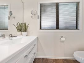 A bathroom with a sink and toilet at Nukuhau Bliss - Taupo Holiday Home Taupo Central
