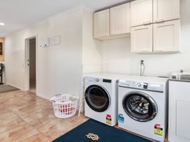A laundry room with washing machine and dryer at Nukuhau Bliss - Taupo Holiday Home, Taupo Central