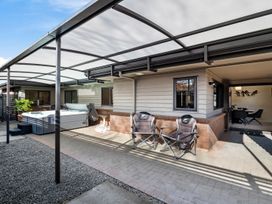 An outdoor area with a hot tub and chairs at Nukuhau Bliss - Taupo Holiday Home Taupo Central