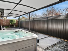 An outdoor area with a hot tub and patio cover at Nukuhau Bliss - Taupo Holiday Home, Taupo Central