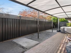 An outdoor area with a hot tub and fenced enclosure at Nukuhau Bliss - Taupo Holiday Home, Taupo Central