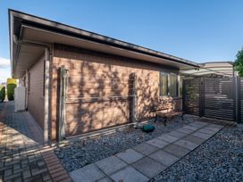 An outdoor area with a bench and pathway at Nukuhau Bliss - Taupo Holiday Home Taupo Central