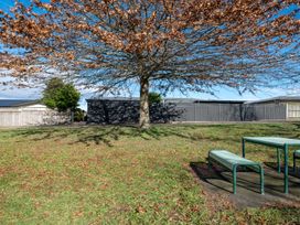 An outdoor area with a table under a tree at Nukuhau Bliss - Taupo Holiday Home, Taupo Central