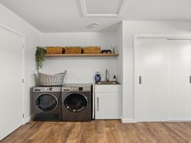 A laundry room with a washing machine and dryer at Harper on Hadley - Cromwell Holiday Home