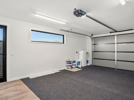 A garage with paint cans and a window at Harper on Hadley - Cromwell Holiday Home Cromwell