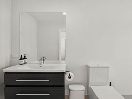 A bathroom with a sink and toilet at Harper on Hadley - Cromwell Holiday Home, Cromwell