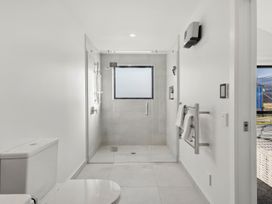 A bathroom with a shower and toilet at Harper on Hadley - Cromwell Holiday Home in Cromwell