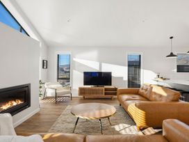 A living room with a sofa and television at Harper on Hadley - Cromwell