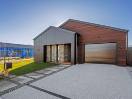 A house with a stone wall and garage at Harper on Hadley - Cromwell