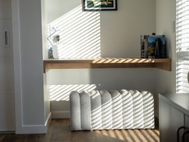 A workspace with a shelf and books at Harper on Hadley - Cromwell Holiday Home, Cromwell